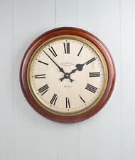 A vintage industrial Synchronome wall clock.