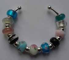 CUFF BRACELET WITH CHARMS AND ORIGINAL BOX.