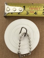1 small White sink plug