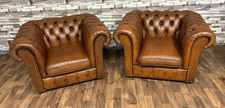 A pair of antique tan leather chesterfield club chairs very sought after colour