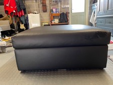 Fold out single bed in a footstool
