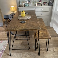 Wooden dining table with matching bench and  two black metal chairs