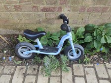 child's blue Puky balance bike