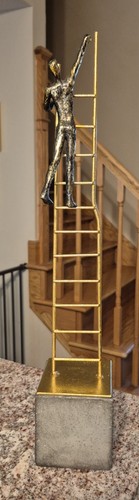 Gold colored climbing man - climbing,