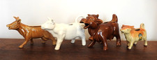 A collection of 4 Cow Creamers. Good Condition