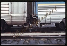 Man working between train cars - train,
