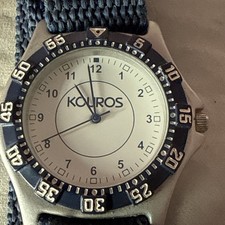 Kouros analog wristwatch with a blue fabric strap.