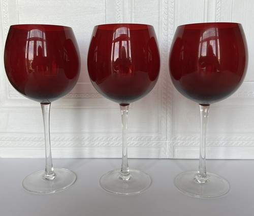 Three large wine glasses with - three,