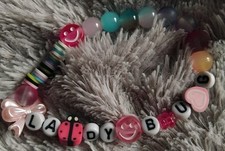 Home Made ladybug Bracelet with ladybird and bow charm.