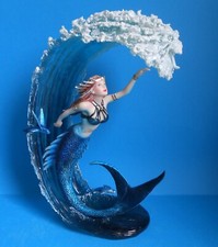 Mermaid Swimming Under Large