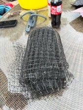 roll of black anti-bird netting, commonly used for protecting plants and crops.
