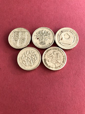 A collection of five old round pound coins