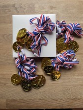 24 plastic Gold Medals for winners with red white and blue ribbon