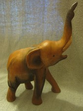 A wooden hand carved elephant. Trumpeting stance.  Unbranded. Good condition