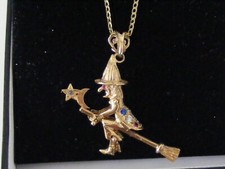 AN ARTICULATED 9ct GOLD GEM ENCRUSTED WITCH ON A 18" CURB LINK CHAIN. 9.9grms