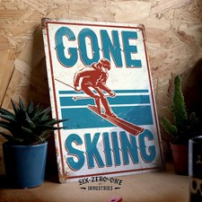GONE SKIING Metal sign. Worn