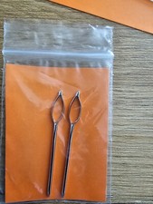 A pair sister locs/ locks retightening hair tool needle