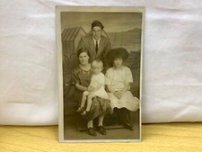 Parents & Two Girls posing in front of beach scene for K Ltd photo postcard
