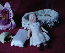 Sweet Vintage Doll all bisque,Cradle made of Wicker