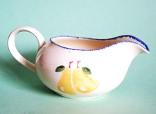 A vintage hand painted Poole Pottery milk jug in the Dorset Fruit range.