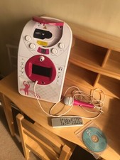 Easy Karaoke machine in pink and white with Mega Kits CD and microphone