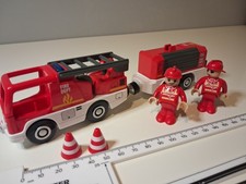 Fire Engine And Trailer With Flashing Lights And Two Firemen