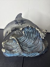 Wax Dolphin Riding Waves