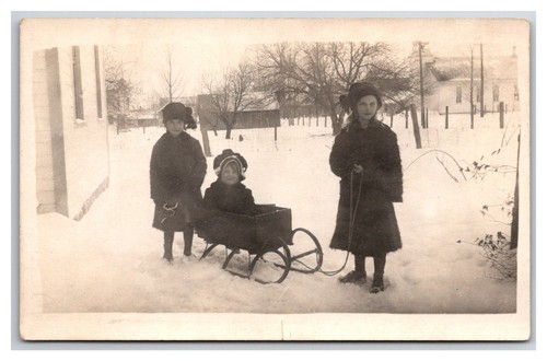 Rppc older sisters pulling - older,
