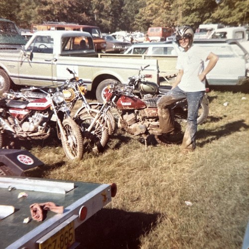 Man posing with motorcycles