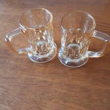 TWO  MINIATURE/SMALL IRIDESCENT TANKARDS. PALE ORANGEIN COLOUR- 6.1/2 CM/2 .1/2"