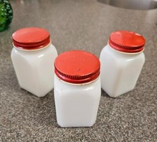 VINTAGE 1950'S MILK GLASS RED METAL TOP BOTTLES SHAKERS? TEA? JARS MADE USA