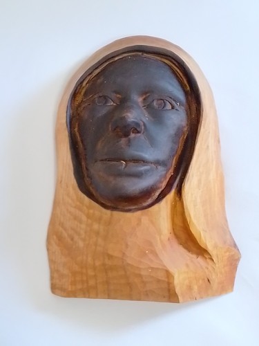 Wooden hand carved face - hand, in