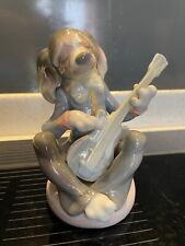 Lladro dog playing guitar - seated