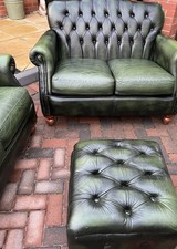 A Pair Of Leather Thomas Lloyd Sofas & An Ottoman In Racing Green Colour