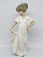 Nao Figurine HOW PRETTY 1110 girl holding white dress. In excellent condition.