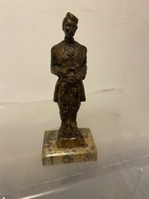 Vintage sculpture of a man standing on a marble base