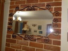 Vintage shaped wall mirror bevelled edge and black wrought iron fancy surround