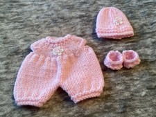 Hand knitted dolls clothes to
