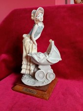 signed A Belcari , Very Decorative Lady With Pram. ceramic figurine.
