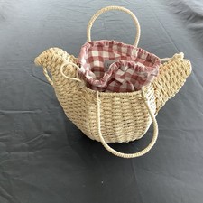 unique, hand-woven bag shaped like a bird, made from a natural material