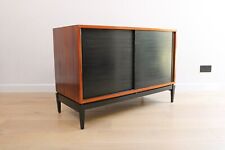 A vintage mid-century rosewood sideboard with ebonised sliding doors and feet