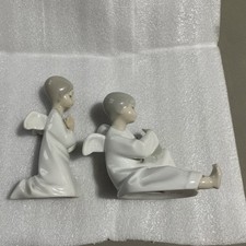 Two Lladro Nao Cherubs One Playing A Harp Other Saying His Payers. Superb Con.