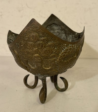 An antique brass footed dish bowl.