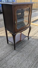 Small vintage mahogany display cabinet on long legs with velvet covered adjustab