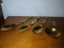 Set of four decorative brass