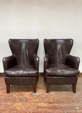 Pair of matching leather wingback armchairs