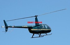 PHOTO  ROBINSON R44 RAVEN HELICOPTER REGISTRATION G-HTEL IS ABOUT TO LAND AT OBA
