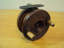 An Antique Wooden Star Backed Fishing Reel With Brass Fittings