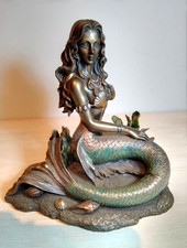 Mermaid Sitting on Ocean Floor