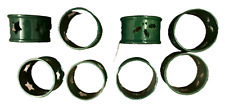 8 x green napkin rings, 4 holly design and 4 star design